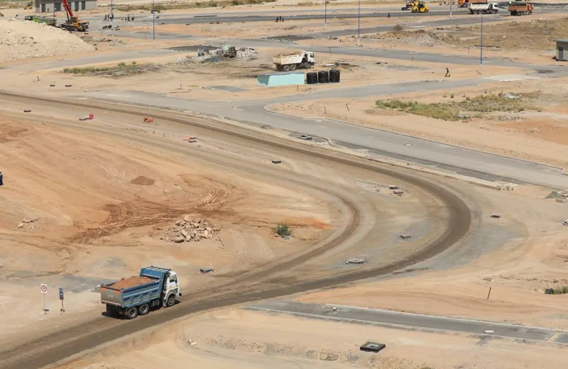 Trucks moving through a construction site in Konza, Kenya